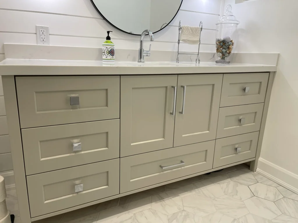 photo-bathroom-vanity-with-drawers-sink-faucet-round-mirror-soap-dispenser-towel-stand-glass-jar-decor-hex-tile-floor