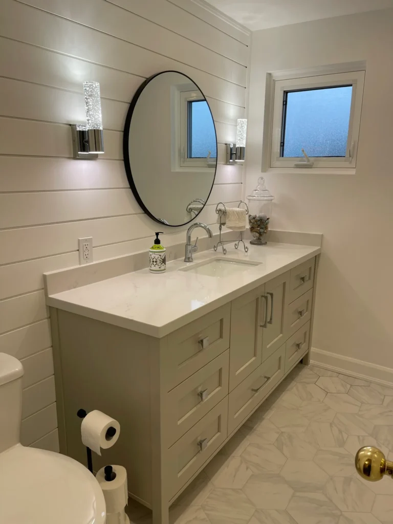 photo-bathroom-vanity-with-round-mirror-wall-lights-window-quartz-countertop-hex-tile-floor-how-to-plan-a-bathroom-renovation-example