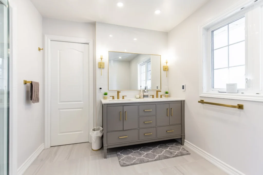 photo-modern-bathroom-vanity-with-double-sinks-gold-fixtures-mirror-window-towel-bars-how-to-plan-a-bathroom-renovation-layout-example