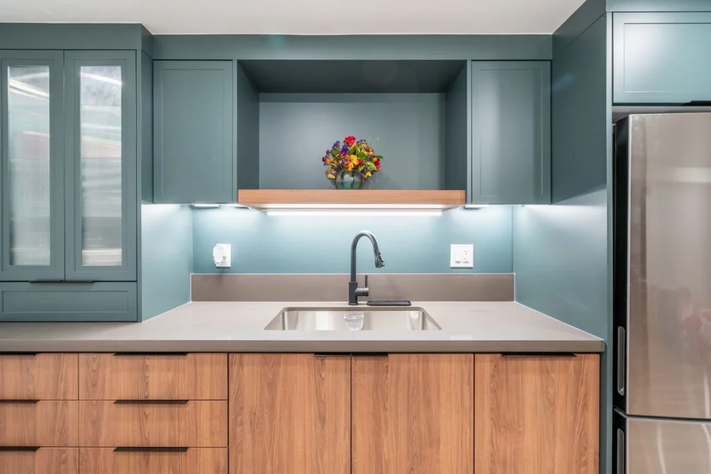 photo-of-a-kitchen-renovation-checklist-inspired-cleanup-zone-featuring-teal-cabinets-wood-lower-cabinets-gray-quartz-countertop-and-matte-black-fauce