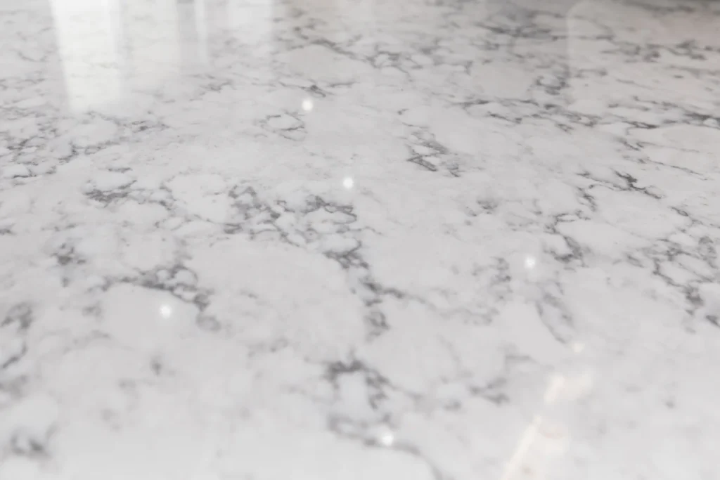 photo-of-a-polished-white-marble-countertop-with-gray-veining-and-a-glossy-reflective-surface