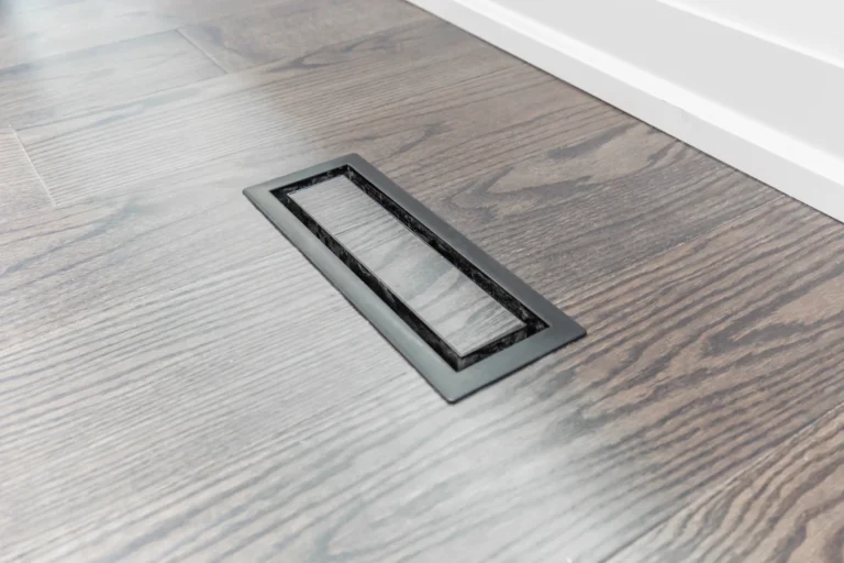 Photo floor vent set into dark hardwood flooring