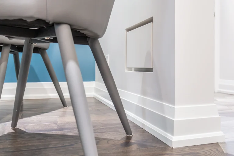 Photo recessed wall vacuum inlet beside dining chair legs
