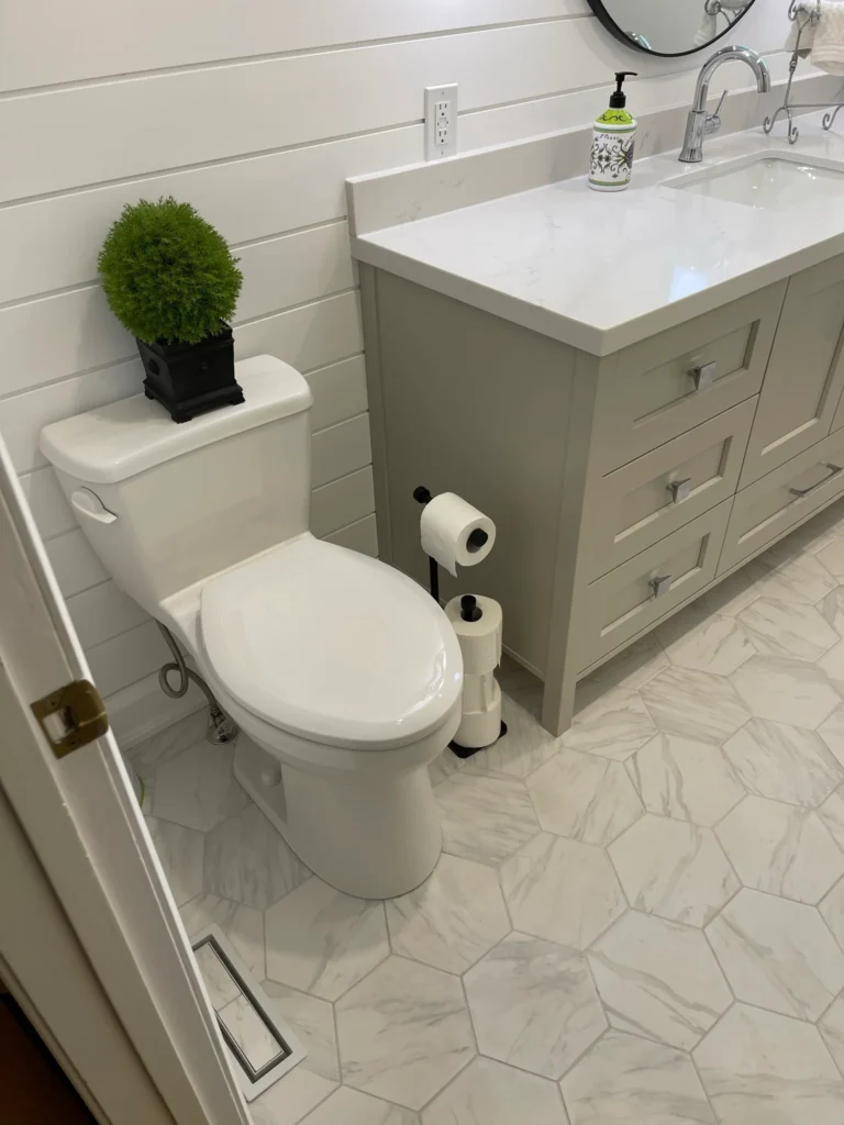 photo bathroom renovations for seniors with white toilet gray vanity and hexagon tile flooring