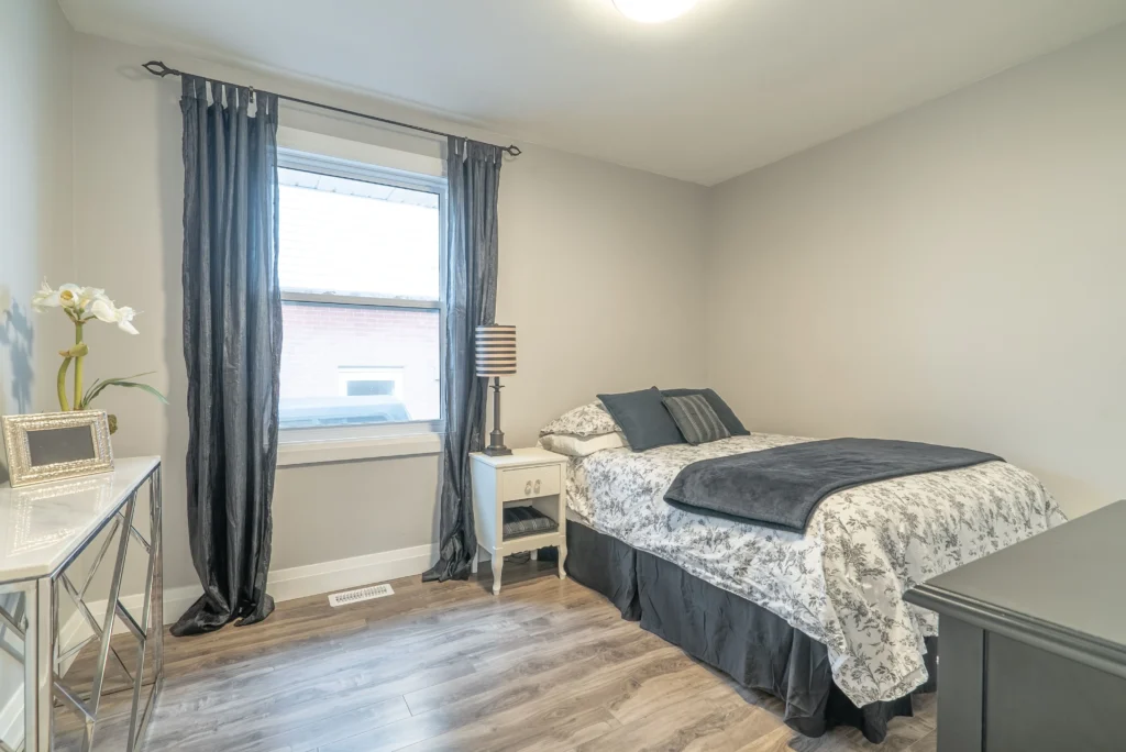Photo bedroom with gray floral bedding wood floors example of which room to renovate first