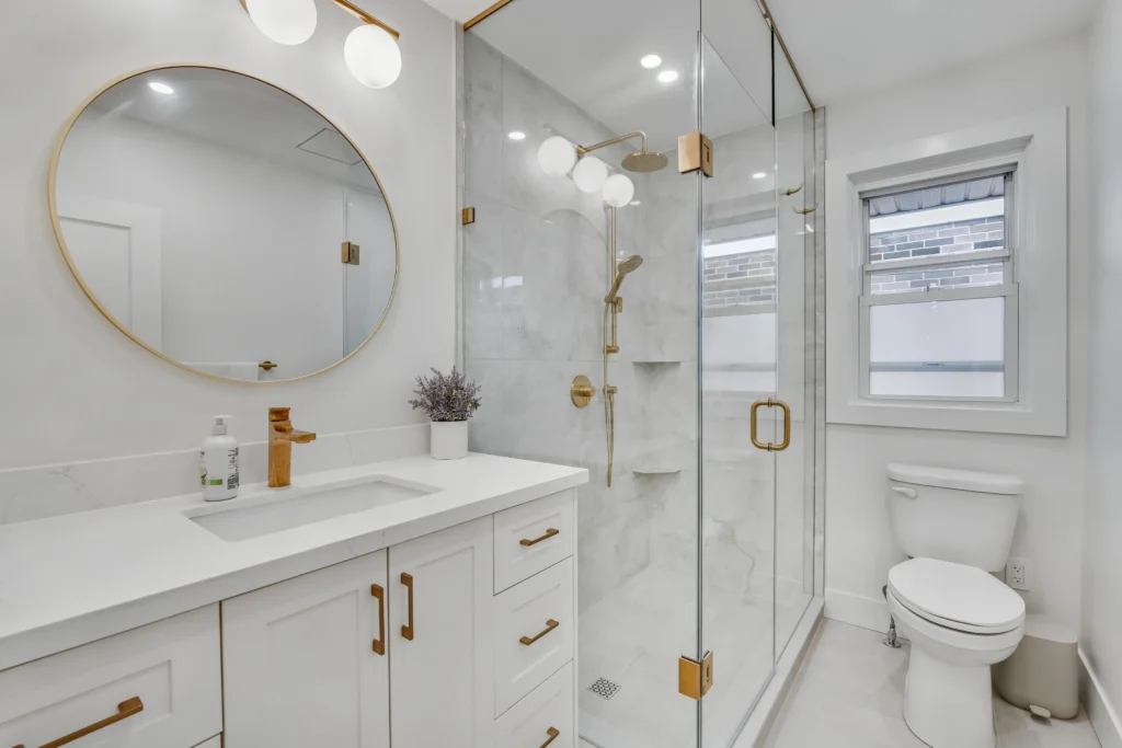 Photo white bathroom glass shower brass fixtures round vanity mirror