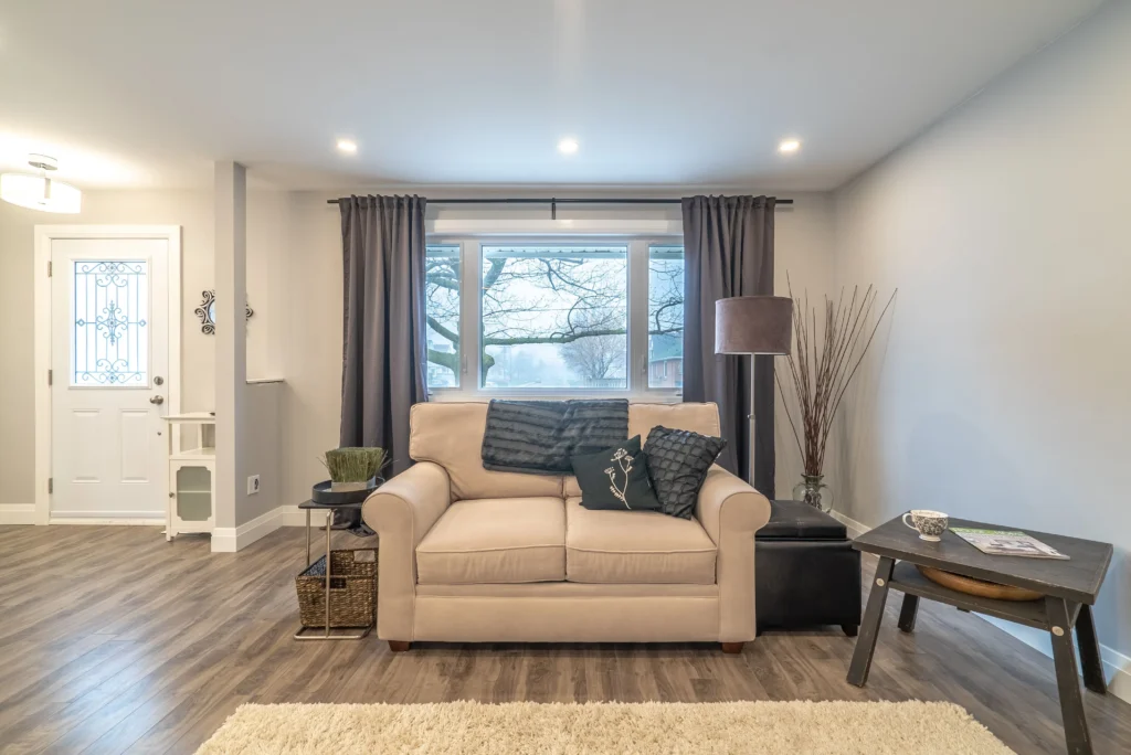 Photo bright living room after home renovations smithville with beige loveseat and large front window